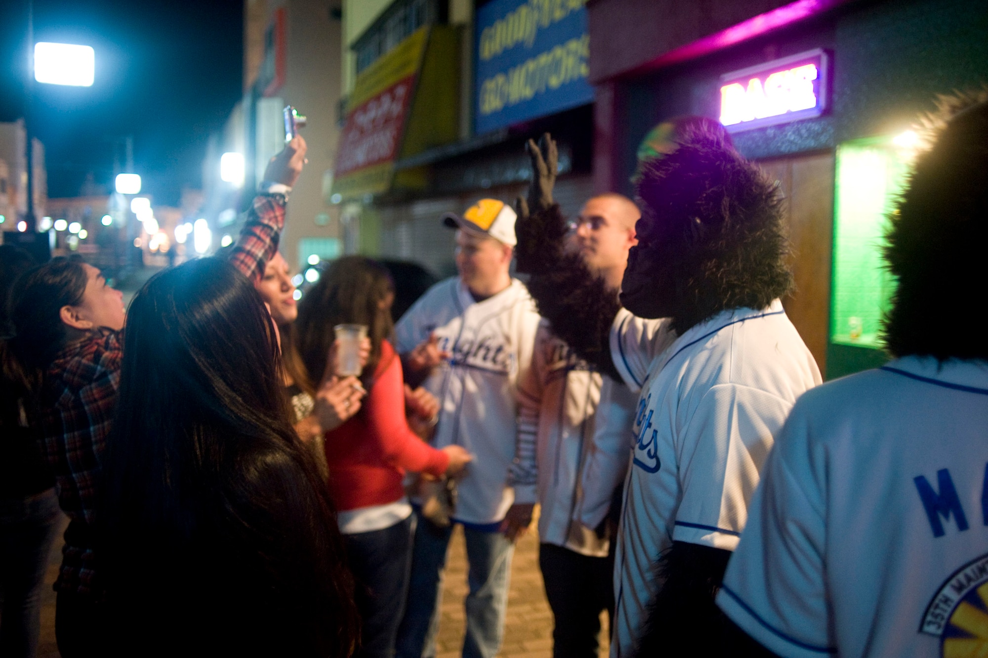 MISAWA AIR BASE, Japan -- Members of Monkeys Against Drunk Driving mingle with the crowd outside a local bar Nov. 15. The monkeys spread the word about their organization, which offers free rides home to members of the Misawa Air Base community. M.A.D.D. regularly sets up its tent in the Base Exchange parking lot and has given 675 people safe rides home since they started Aug. 8. (U.S. Air Force photo/Staff Sgt. Samuel Morse)