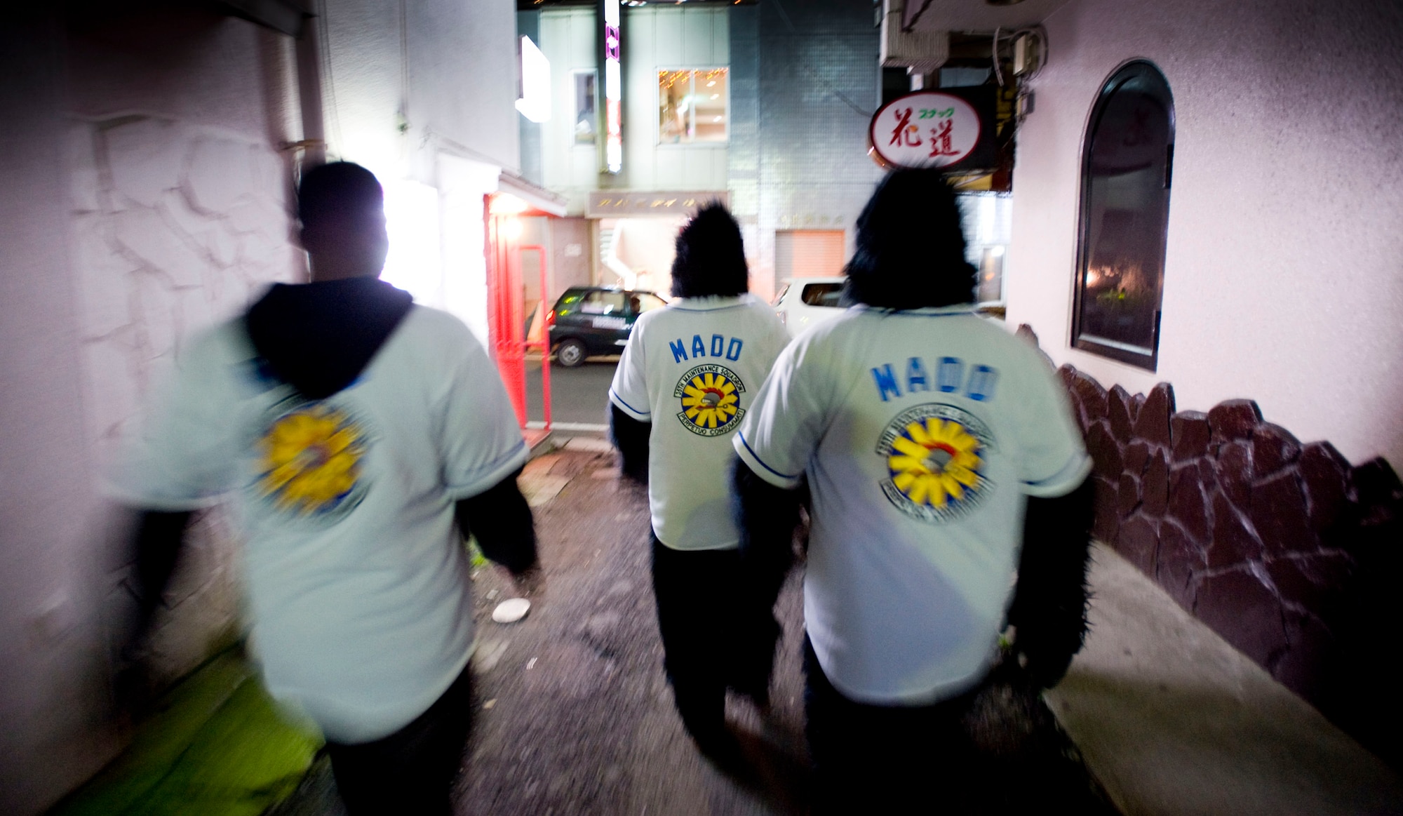 MISAWA AIR BASE, Japan -- Monkeys Against Drunk Driving members walk through an alley in downtown Misawa Nov. 15. The M.A.D.D. jerseys display the 35th Maintenance Squadron shield. M.A.D.D. regularly sets up its tent in the Base Exchange parking lot and has given 675 people safe rides home since they started Aug. 8. (U.S. Air Force photo/Staff Sgt. Samuel Morse)