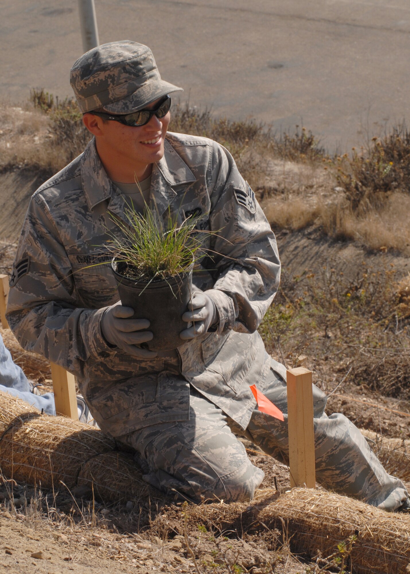 VANDENBERG AIR FORCE BASE, Calif.--Preparing to plant some vegetation, Senior Airman Robert Chavez, member of the 30th Civil Engineer Squadron, helps out during National Public Lands Day here Friday, Nov. 13, 2009. The boathouse has been part of the Vandenberg since 1936, when it was used as a rescue station for the U.S. Coast Guard. (U.S. Air Force photo/Airman 1st Class Kerelin Molina)