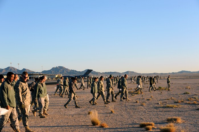 NELLIS AIR FORCE BASE, Nev. -- Nellis Airmen walk between the taxi-ways on the flightline looking for foreign object debris Nov. 16. Nellis conducted a FOD walk after hosting the 2009 Aviation Nation Nellis Open House. FOD prevention is every individual's responsibilities as it can cost millions of dollars, and cause damage to aircraft systems or weapons or injury to personnel. (U.S. Air Force photo by Airman 1st Class Brett Clashman)