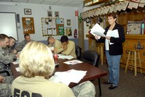 MINOT AIR FORCE BASE, N.D. -- Barbara Peterson, 5th Force Support Squadron Airman and Family Readiness Center community readiness consultant, briefs 5th Civil Engineer Squadron explosive ordinance disposal Airmen as they joined fellow EOD technicians across the Air Force during their safety day Nov. 9 here. The purpose of EOD Safety Day is to review how EOD functions, from standard operating procedures, tactics, techniques and procedures to the health of the EOD career field. (U.S. Air Force photo by Airman 1st Class Jesse Lopez)