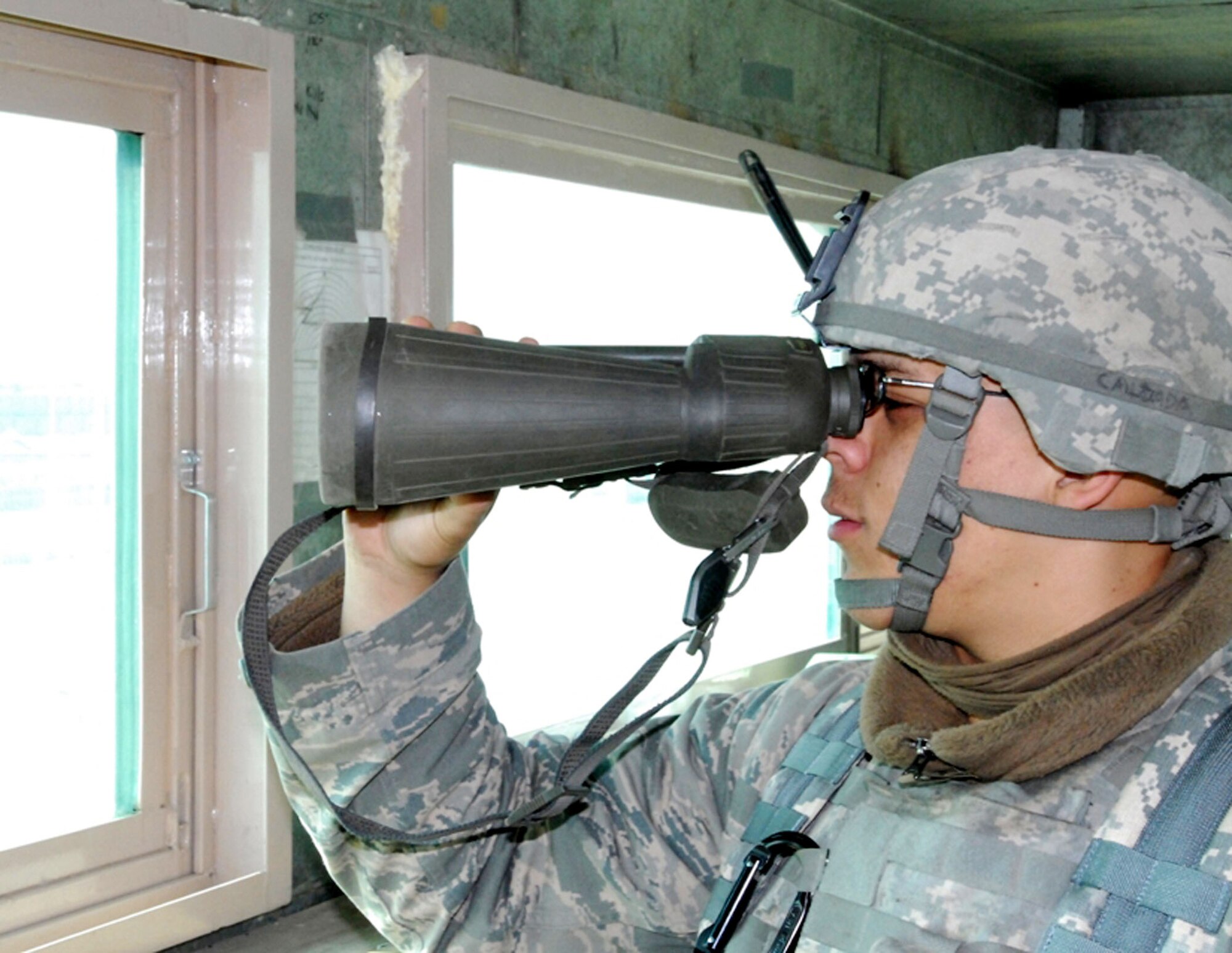 Airman Aaron Calzada watches a group of locals near the perimeter at an entry control point Oct. 29, 2009, at Bagram Airfield, Afghanistan. Airman Calzada is assigned to the 455th Expeditionary Security Forces Squadron deployed from Holloman Air Force Base, N.M. He is a native of Lancaster, Calif. (U.S. Army photo/Spc. William E. Henry)