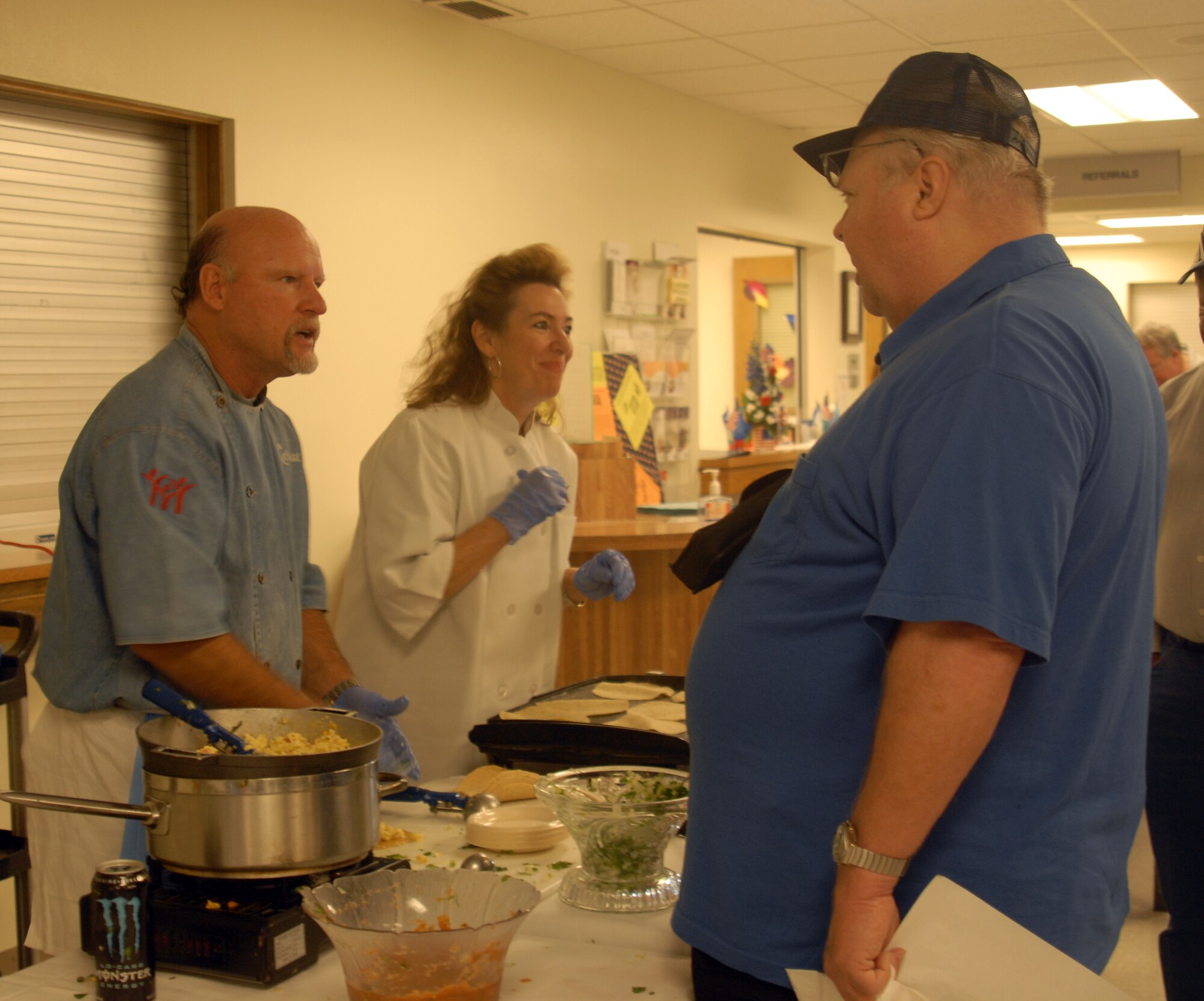 Chef Henry Wiens, executive chef and director, Food and Nutrition Department, San Angelo Community Medical Center and Ms. Brenda Scarpa, Education Service Center Region XV, prepare and serve breakfast tacos to military retirees during the Goodfellow Military Retirees Appreciation Day and Health Fair, Nov. 14 at the Goodfellow clinic. ( U.S. Air Force photo/ Airman 1st Class Anne Gathua)

