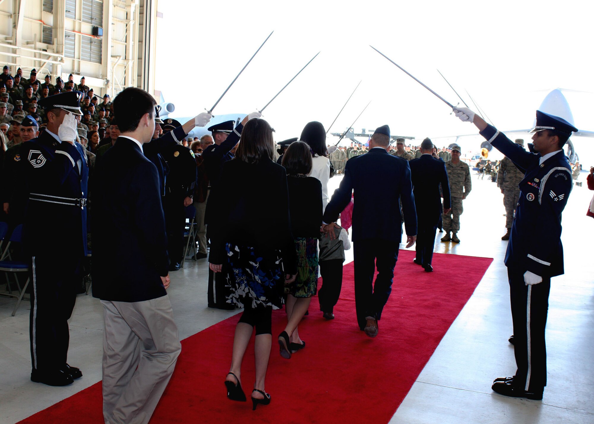 TRAVIS AIR FORCE BASE, Calif. -- Col. John (Jay) C. Flournoy, Jr., and his family depart through an arc of sabers after the change of command ceremony here Nov. 15, 2009. Colonel Flournoy assumes command of the Air Force Reserve Command’s largest associate wing from Brig. Gen. Maryanne Miller, who has been assigned to a position in the Pentagon. The ceremony was well attended by members of Team Travis and the local community. The change of command ceremony is a time-honored tradition which formally symbolizes the continuity of authority as the command is passed from one officer to another.  (U.S. Air Force photo / Lt. Col. Robert Couse-Baker)