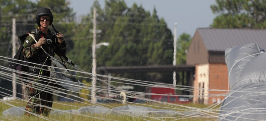 MOODY AIR FORCE BASE, Ga. -- Senior Airman James Gibson, 38th Rescue Squadron pararescueman, removes his equipment after a free-fall jump from an HC-130P Combat King during a training exercise here Oct. 29. The HC-130P aircraft is specifically configured for combat search and rescue missions. (U.S. Ai r Force photo by Staff Sgt. Elizabeth Rissmiller)