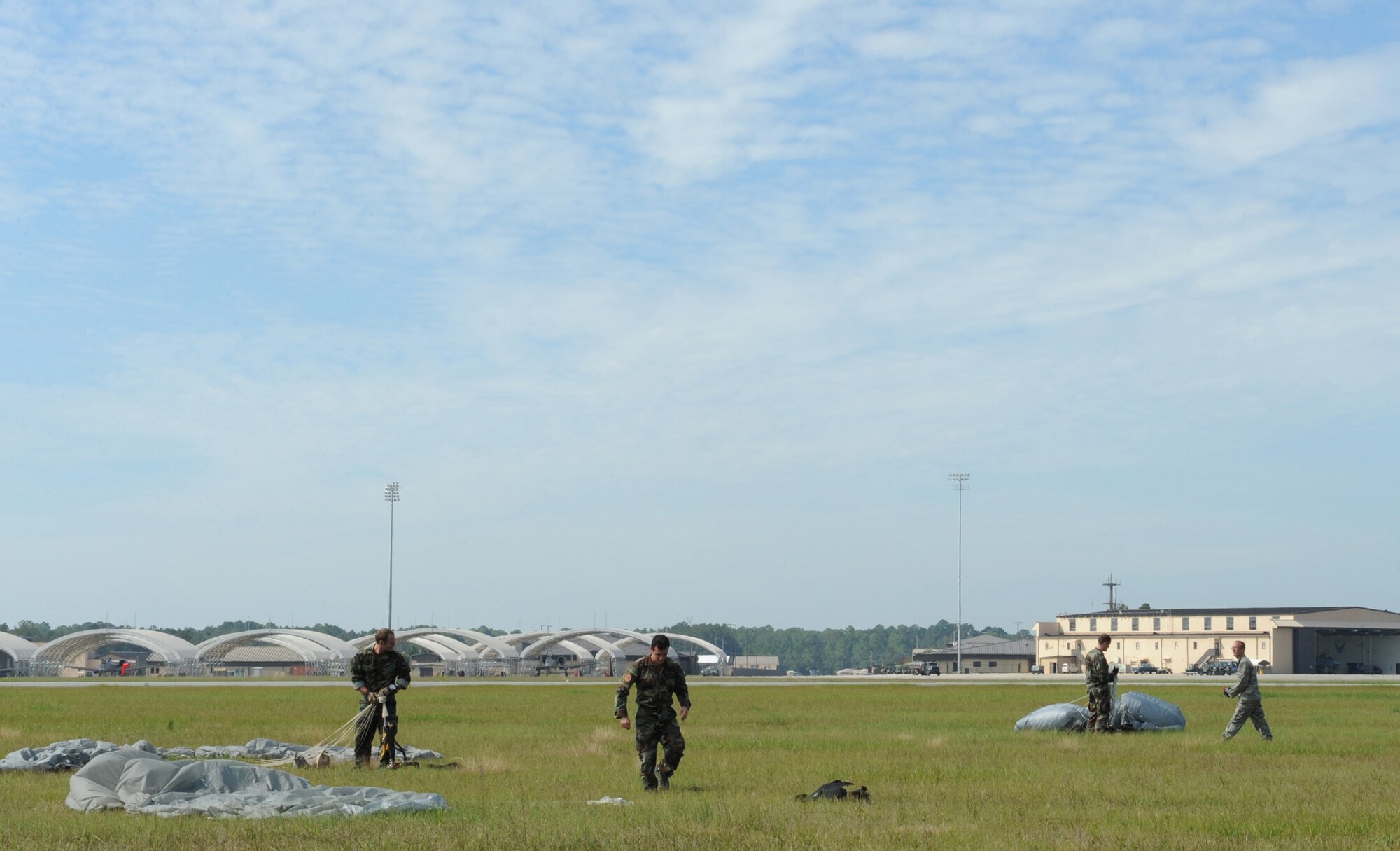 MOODY AIR FORCE BASE, Ga. -- Members of the 38th Rescue Squadron pack up their parachutes and clear the drop zone after a free-fall jump here Oct. 29. The 38th RQS conducts training jumps weekly. (U.S. Air Force photo by Staff Sgt. Elizabeth Rissmiller)