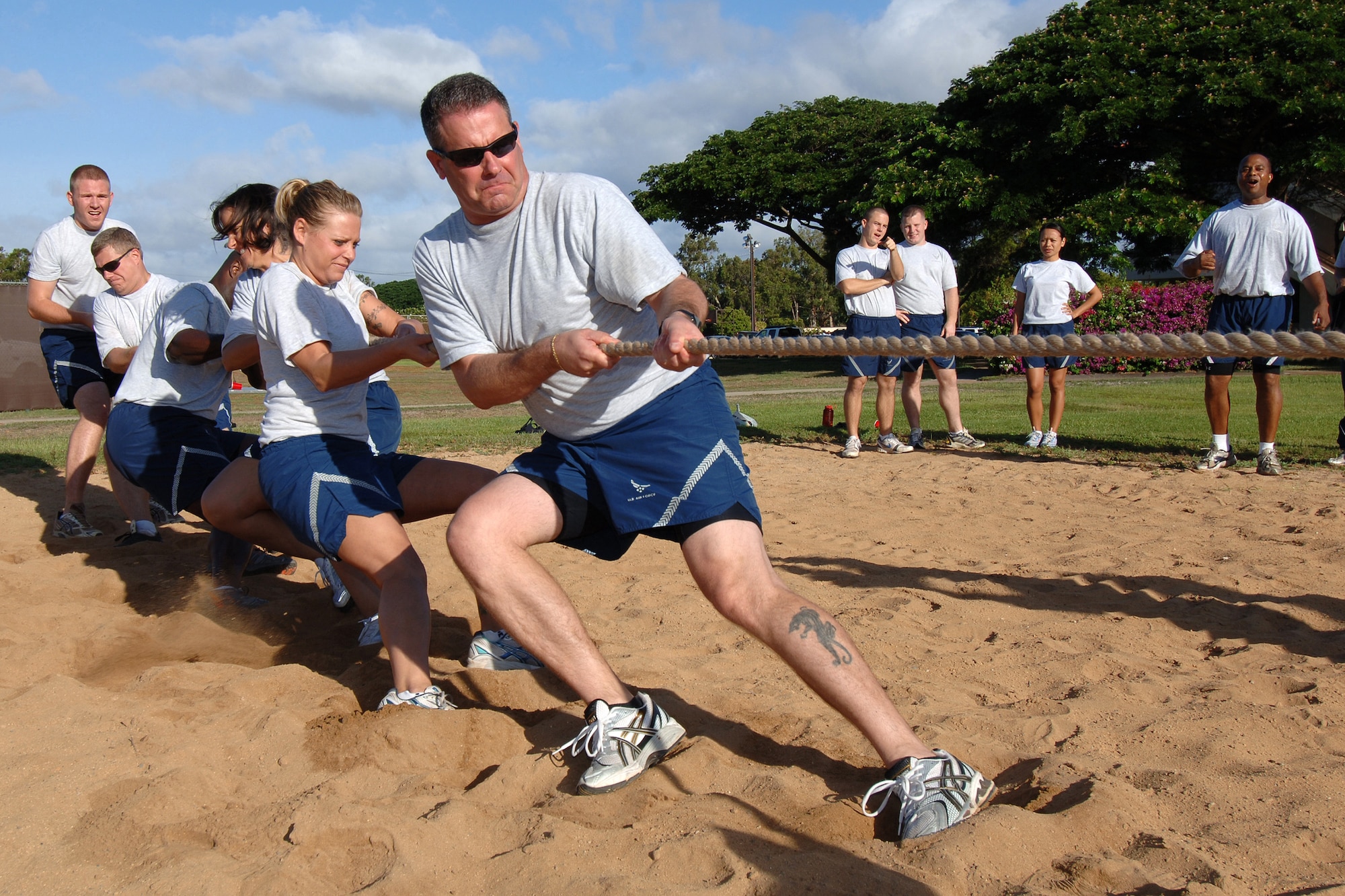Members of 13th Air Force compete in a traditional battle of Tug-O-War during a Jungle Day sporting event held Nov.13 at Hickam Air Force Base, Hawaii.  Jungle Day is a tradition that originated when the organization was assigned to Andersen Air Force Base, Guam, and gives 13th Air Force members a chance to have fun and give back to the local community.  (U.S. Air Force photo by Vanessa M. Forloine)  
