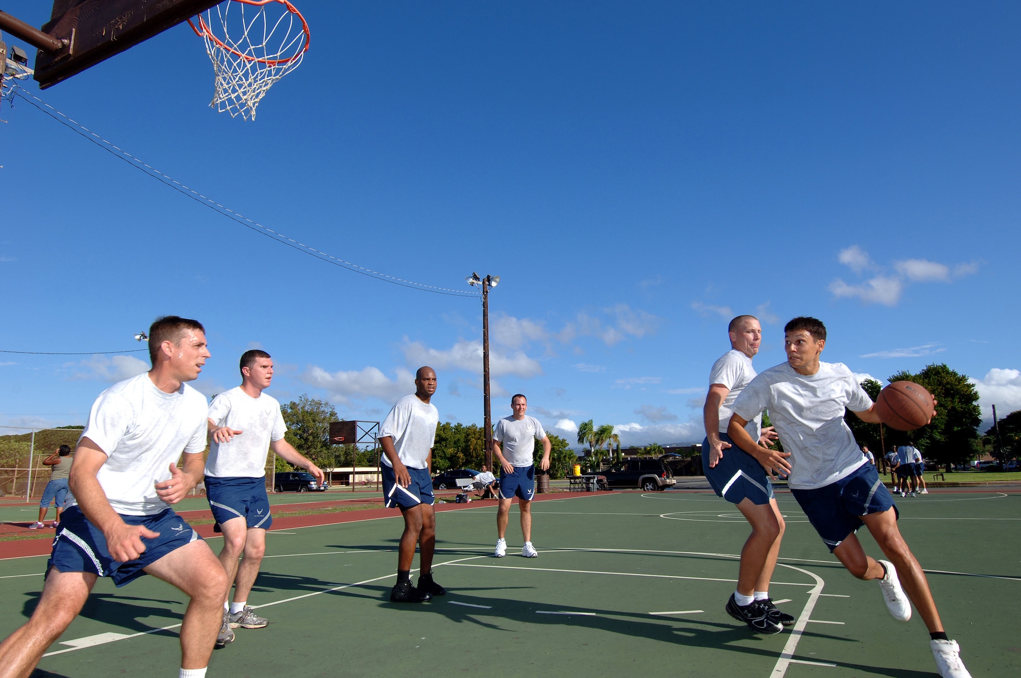Members of 13th Air Force compete in a 3-on-3 Basketball tournament during a Jungle Day sporting event held on Nov.13 at Hickam Air Force Base, Hawaii.  Jungle Day is a tradition that originated when the organization was assigned to Andersen Air Force Base, Guam, and gives 13th Air Force members a chance to have fun and give back to the local community. (U.S. Air Force photo by Vanessa M. Forloine)  