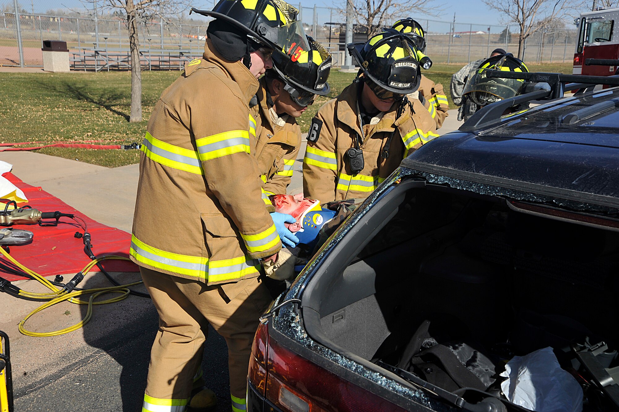 21st Space Wing firefighters extract a critically injured driver from a car that was hit head-on by a suspected drunk driver. The simulated drunk driving crash Nov. 10 on Peterson Air Force Base was hosted by U.S. Northern Command. The anti-drug event, Every 15 Minutes, is a national program first designed for high school students and meant to give them a graphic visual image of how a drunken driving crash plays out. This is the first time the program was presented on an Air Force Base, event organizers said. (Air Force photo by Dennis Howk)