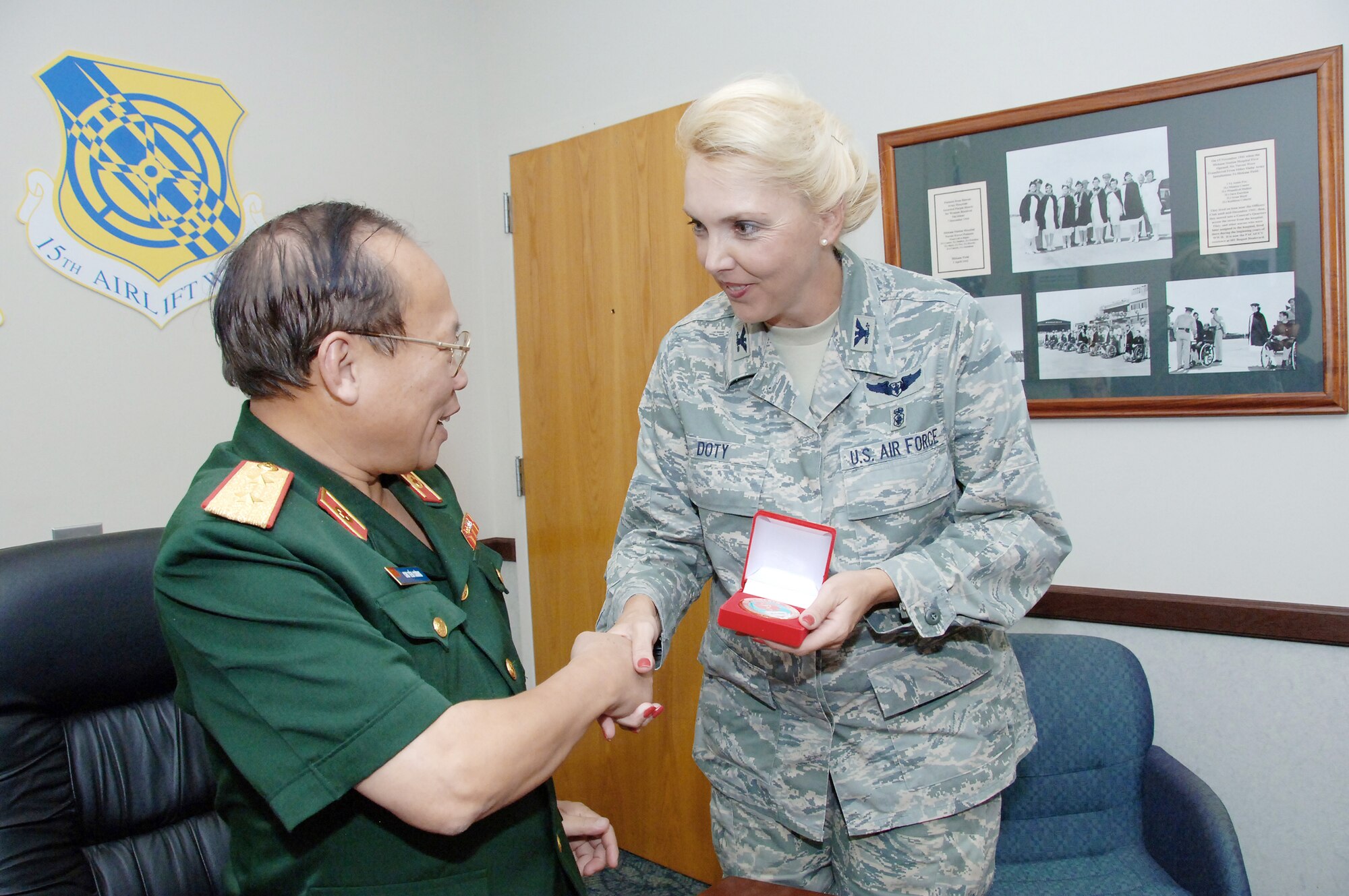 Lt. Gen. Chu, Tien Cuong, director of the Vietnam Military Medical Department, presents Col. Debra Doty, the 15th Medical Group commander, with a Vietnam military medical emblem during a visit to Hickam Air Force Base, Hawaii, Nov. 10, 2009. Six delegates from the Vietnam military health and general logistics fields met with U.S. Air Force officials at Hickam during a 13th Air Force-hosted visit. The delegates learned how the U.S. military conducts surveillance, screening and testing of infectious diseases, and how the U.S. Air Force plans and conducts logistics operations. (U.S. Air Force photo/Vanessa Forloine)
