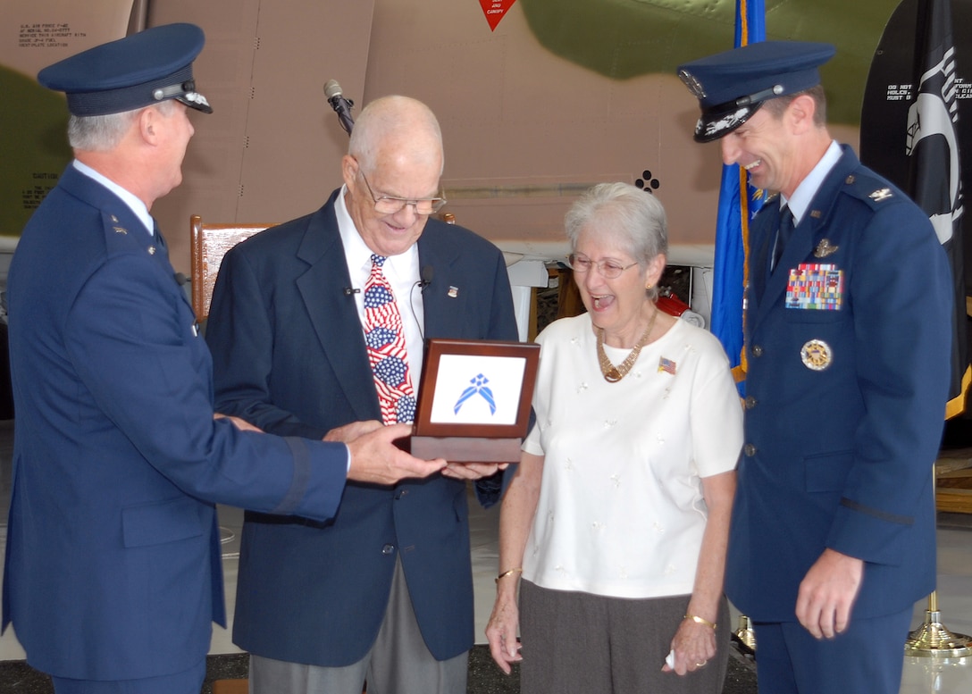 Brig. Gen. O.G. Mannon, left, 82nd Training Wing commander, and Col. Kevin Schneider, 80th Flying Training Wing commander, present a box that contains a wedding ring and dog tag Nov. 11 to retired Air Force Col. James Hivner and his wife, Phyllis, at the Cavanaugh Flight Museum in Addison, Texas. The colonel was shot down 44 years ago over North Vietnam. His North Vietnamese captors confiscated the items, along with a "rat fink" given to him by one of his daughters, when he was taken prisoner. He was released Feb. 12, 1973. (U.S. Air Force photo/Lou Anne Sledge)