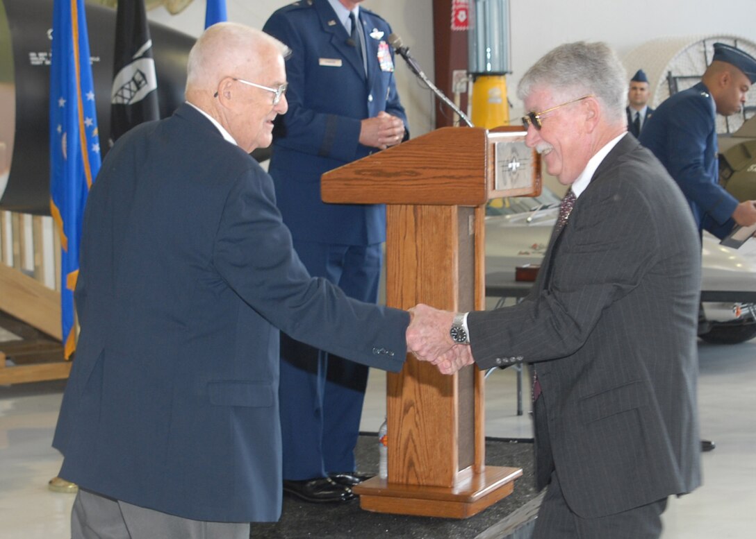 Retired Air Force Col. James Hivner, left, meets retired Navy Cmdr. Rick Tolley Nov. 11 at the Cavanaugh Flight Museum in Addison, Texas. Commander Tolley was contacted about a month ago and was asked to locate and return Colonel Hivner's wedding ring and dog tag. The items were confiscated Oct. 5, 1965, when Colonel Hivner was shot down over North Vietnam. (U.S. Air Force photo/Lou Anne Sledge)