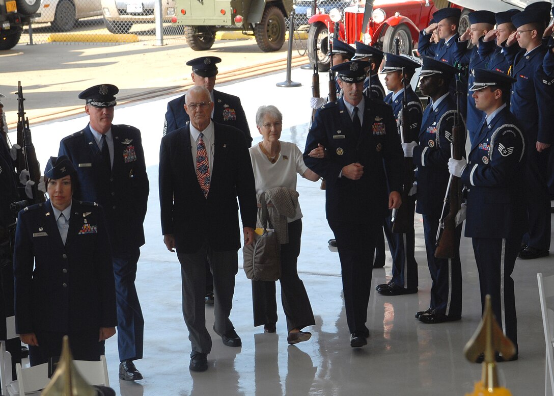 The official party arrives at the Cavanaugh Flight Museum in Addison, Texas, Nov. 11 for a ceremony that would reunite a former Air Force aviator and his wife with his original wedding ring 44 years after it was confiscated by the North Vietnamese. Retired Air Force Col. James Hivner and his wife, Phyllis, make their way through Sheppard Air Force Base's honor guard assisted by 82nd Training Wing Commander Brig. Gen. O.G. Mannon, left, and Col. Kevin Schneider, 80th Flying Training Wing commander, right, and Chief Master Sgt. Kenneth Sallinger, 82nd TRW command chief master sergeant. Colonel Hivner's ring and dog tag were confiscated by the North Vietnamese army 44 years ago when he was shot down Oct. 5, 1965. (U.S. Air Force photo/Lou Anne Sledge)