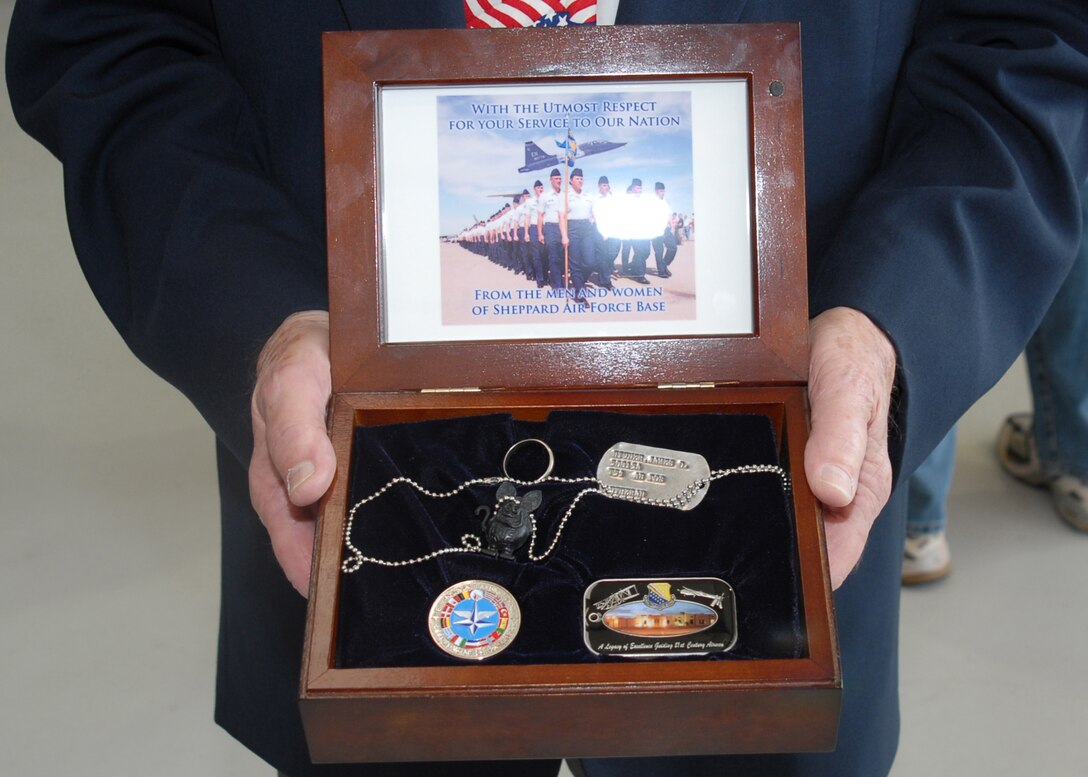 A small wooden box holds a few items that didn't return with retired Air Force Col. James Hivner Feb. 12, 1973, when he was released as a Vietnam prisoner of war. The colonel was shot down Oct. 5, 1965, and was captured within 10 minutes of ejecting. His dog tag, wedding ring and a "rat fink" were confiscated. They were returned 44 years later. (U.S. Air Force photo/Lou Anne Sledge)