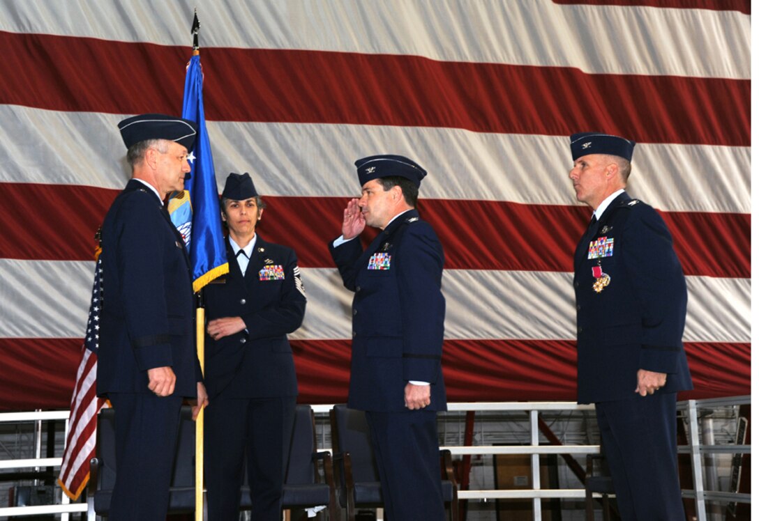 Brig. Gen. Eric W. Crabtree, commander of 4th Air Force, receives a salute from Col. William H. Edwards, Jr., who took command of the 932nd Airlift Wing as Col. John C. Flournoy, Jr. (right) moved to become commander of the 349th Air Mobility Wing at Travis AFB, Ca. Holding the wing flag during the ceremony is Command Chief Master Sgt. Sandra Santos  (U.S. Air Force photo/Tech. Sgt. Gerald Sonnenberg).