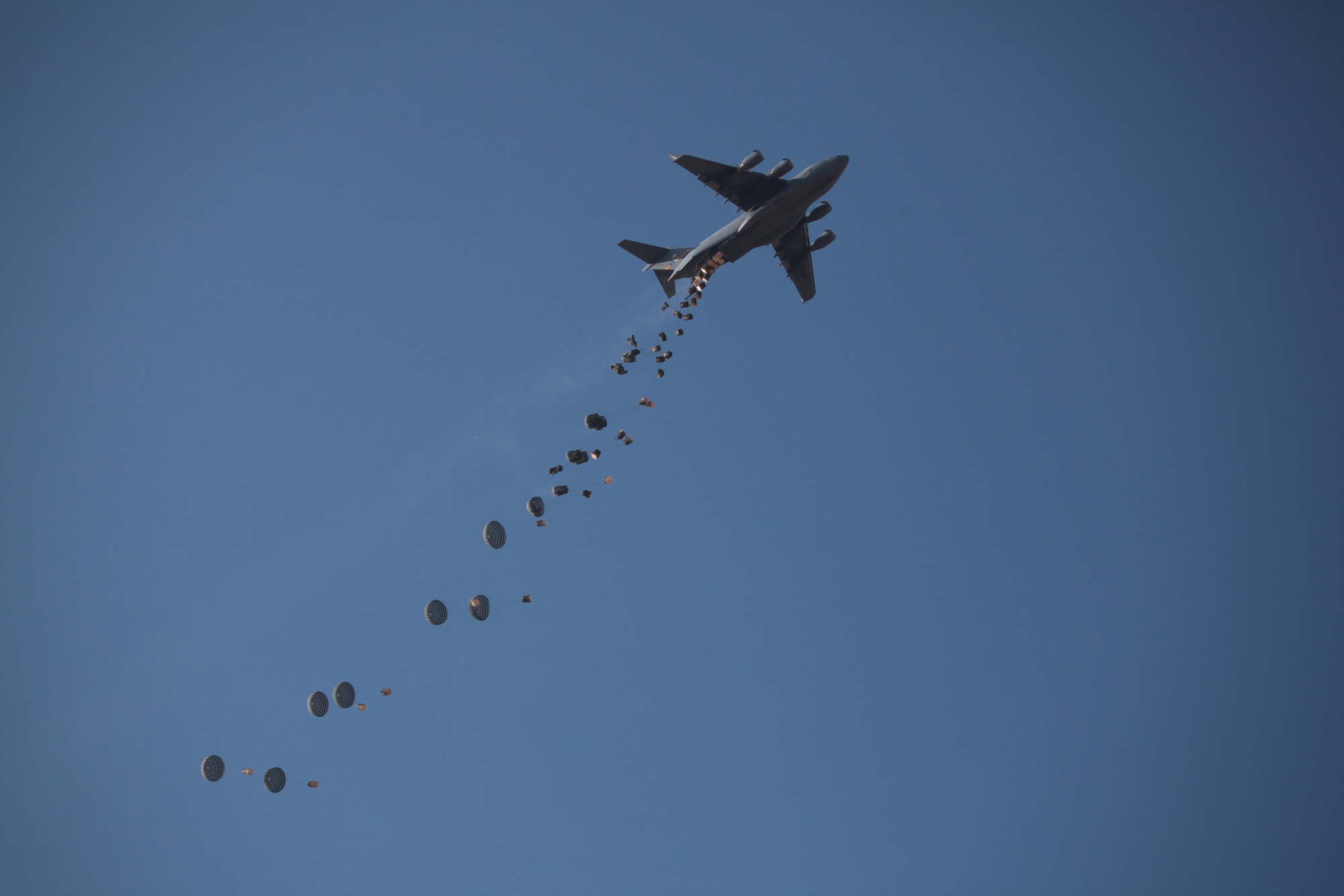 A U.S. Air Force C-17 Globemaster III airdrops supplies outside Forward Operating Base Golestan in the Helmand Province, Afghanistan, on Oct. 28, 2009. U.S. Marines with 2nd Platoon, India Company, 3rd Battalion, 4th Marine Regiment rely on supply drops to keep operations running smoothly while forward deployed. (U.S. Marine Corps Photo/Lance Cpl. Chad J. Pulliam)