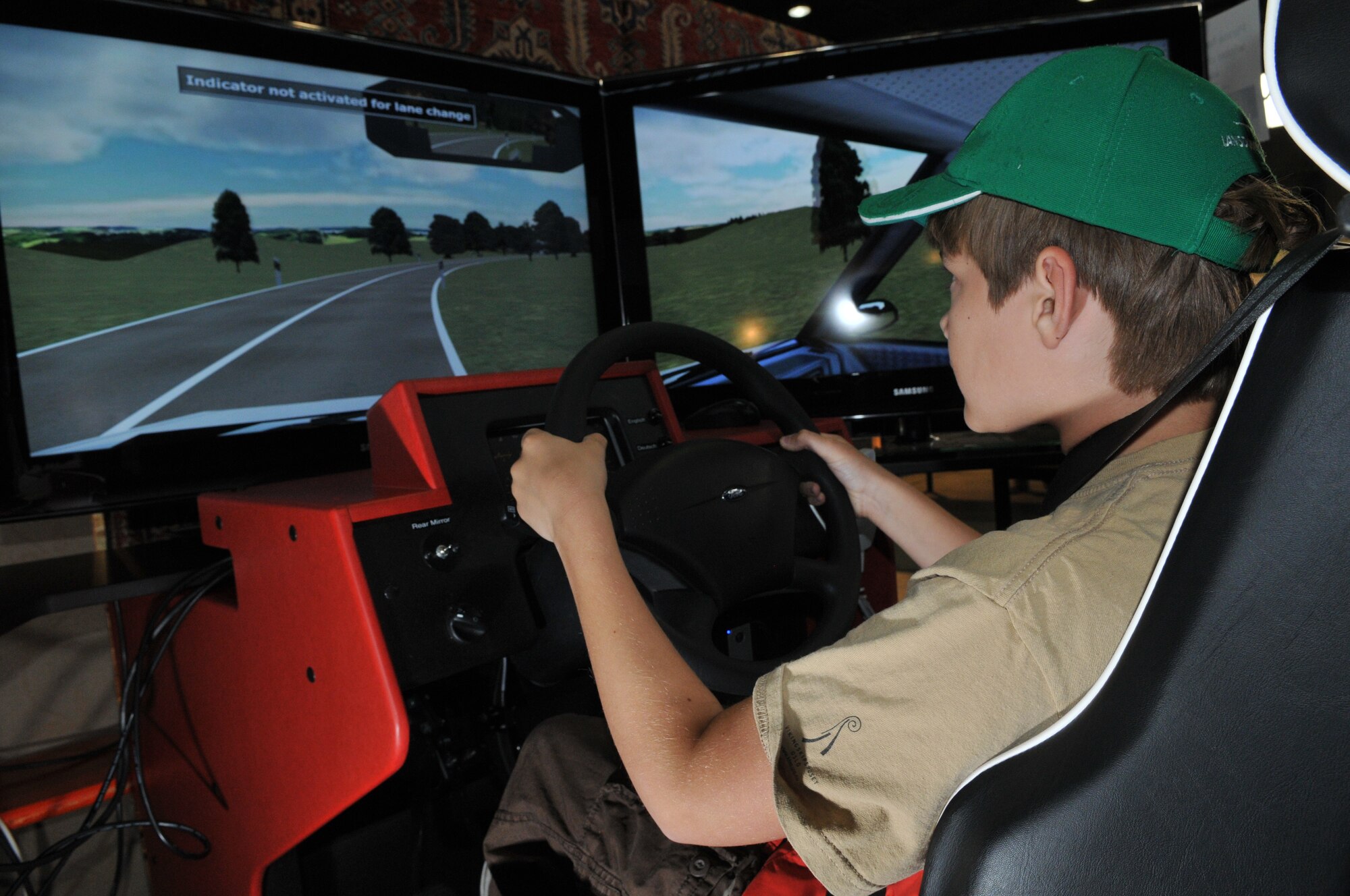 SPANGDAHLEM AIR BASE, Germany -- Alex Wrede, 11-year-old son of Maj. Valorie Wrede, 52nd Medical Operations Squadron, tests out a driving simulator at the Eifel Holiday Bazaar Nov. 13. The bazaar featured more than 100 booths ranging from driver simulators to European vendors selling handmade soaps, wine, jewelry, furniture, clothing and dishware to members of the 52nd Fighter Wing. (U.S. Air Force photo/Airman 1st Class Nick Wilson)