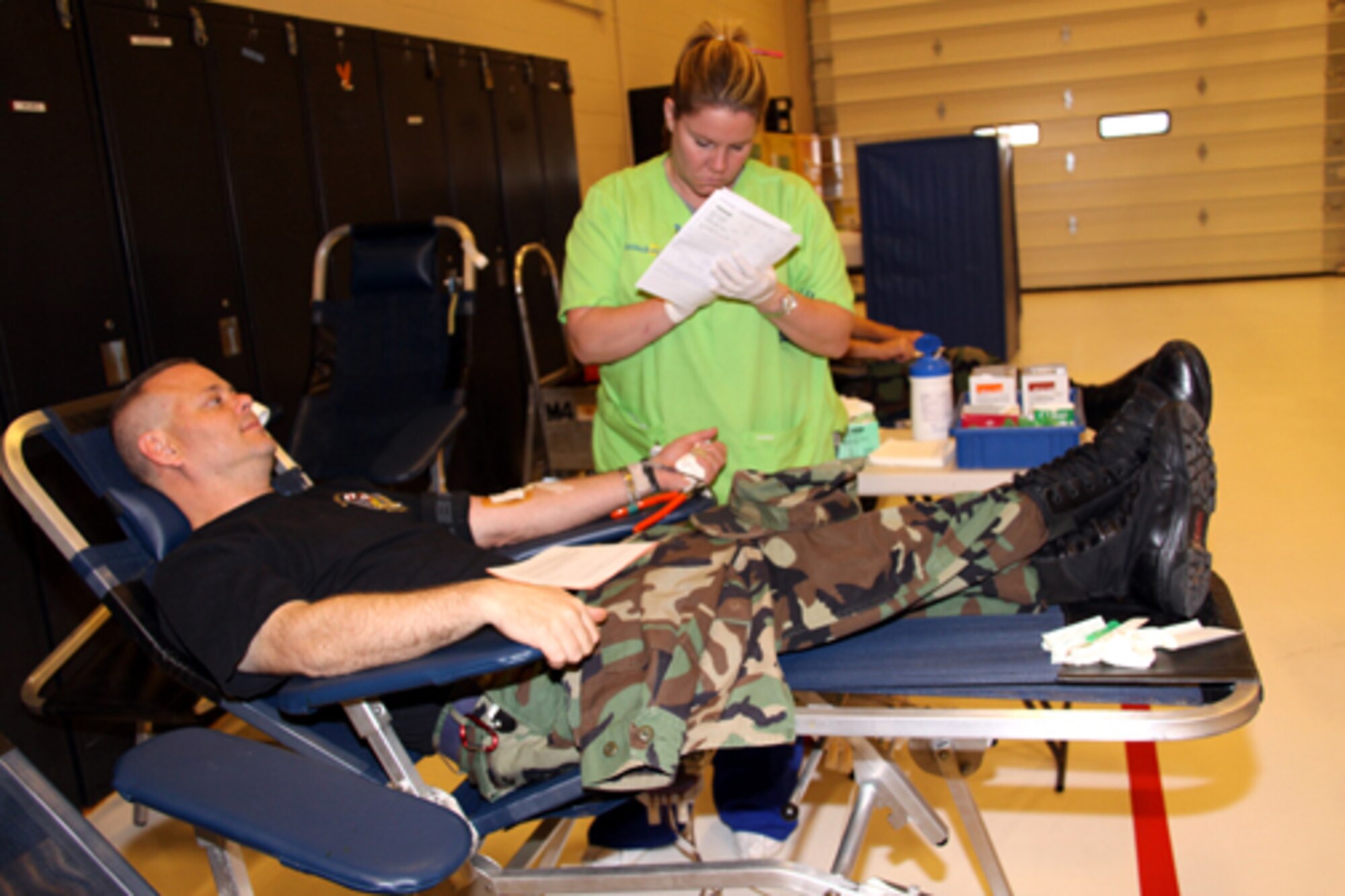 Senior Airman Jeff Moore, 911th Communications Squadron, donates blood as Paula Todd, a phlebotomist, records his information. The blood drive was held on base Nov. 8 and more than 20 units of blood were collected. The drive was conducted by the Central Blood Bank of Pittsburgh. They provide blood to 42 medical facilities in western Pennsylvania, eastern Ohio and northern West Virginia.