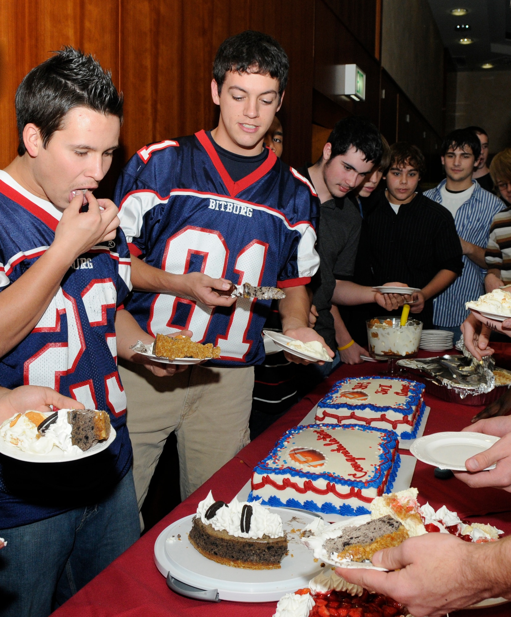 SPANGDAHLEM AIR BASE, Germany – Bitburg Barons players, along with friends and family, gather around the dessert table during a celebration dinner at Club Eifel Nov. 10. The Bitburg Barons won the Department of Defense Dependents Schools-Europe Division II football championship game against the Ansbach Cougars Nov. 7. The Bitburg Barons defeated the Cougars 19-6 and ended the Cougars’ 31-game winning streak to claim the title as Division II champions. (U.S. Air Force photo/Airman 1st Class Staci Miller)