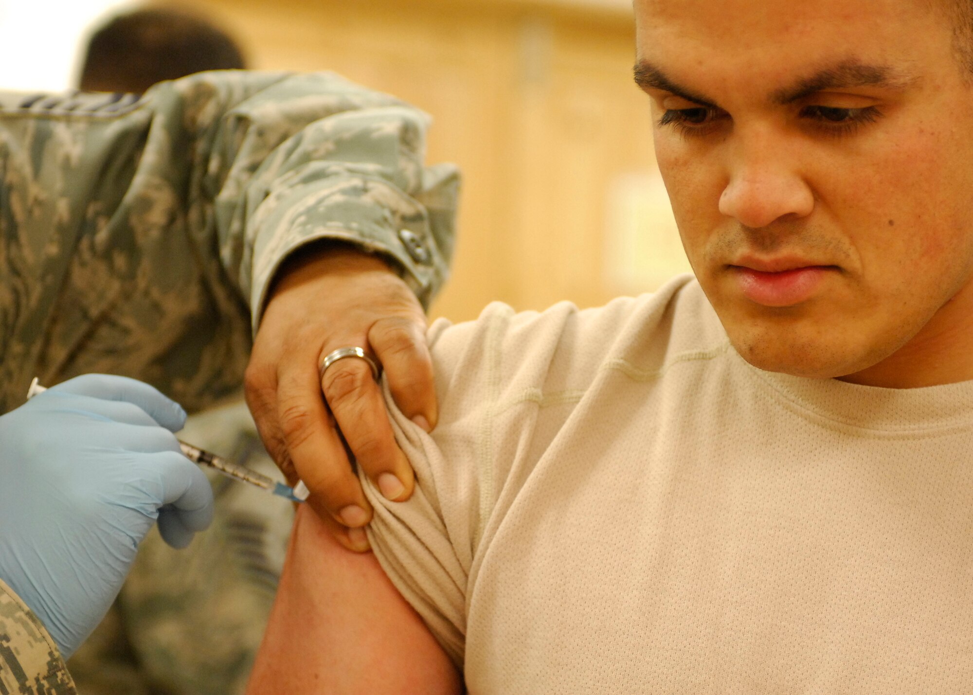 BAGRAM AIRFIELD, Afghanistan -- Senior Master Sgt. Alberto Boykin (left), an intensive care unit flight chief from the 455th Expeditionary Medical Operation Squadron, administers the Influenza A 2009 (H1N1) monovalent vaccine to Senior Airman John Diaz-Colon (right), a 455th Expeditionary Security Forces Squadron member, Nov. 16, 2009.  Airman Diaz-Colon, an El Paso, Texas native, is deployed from Charleston Air Force Base, S.C.  Sergeant Boykin is deployed from Tyndall Air Force Base, Fla., and hails from Mt. Holly, N.J.  (U.S. Air Force photo/Senior Airman Susan Tracy)