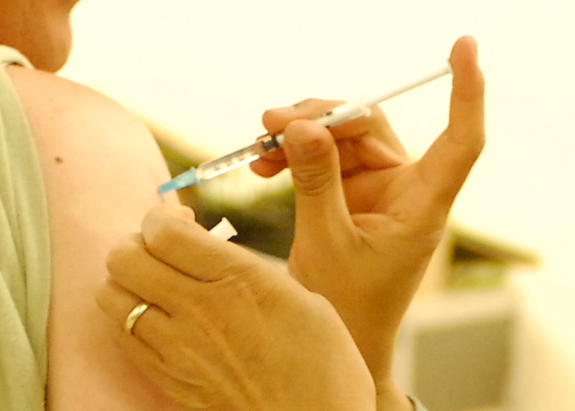 BAGRAM AIRFIELD, Afghanistan -- Master Sgt. Kurt Bohler (left), the medical liaison from the 755th Air Expeditionary Group, receives the Influenza A 2009 (H1N1) monovalent vaccine from Master Sgt. Maria Langston (right), the emergency room non-commissioned officer in charge from the 455th Expeditionary Medical Operation Squadron, Nov. 16, 2009.  Sergeant Bohler is deployed from Wright-Patterson Air Force Base, Ohio, and hails from Joliet, Ill.  Sergeant Langston, a San Antonio native, is deployed from Lackland AFB, Texas.  (U.S. Air Force photo/Senior Airman Felicia Juenke)