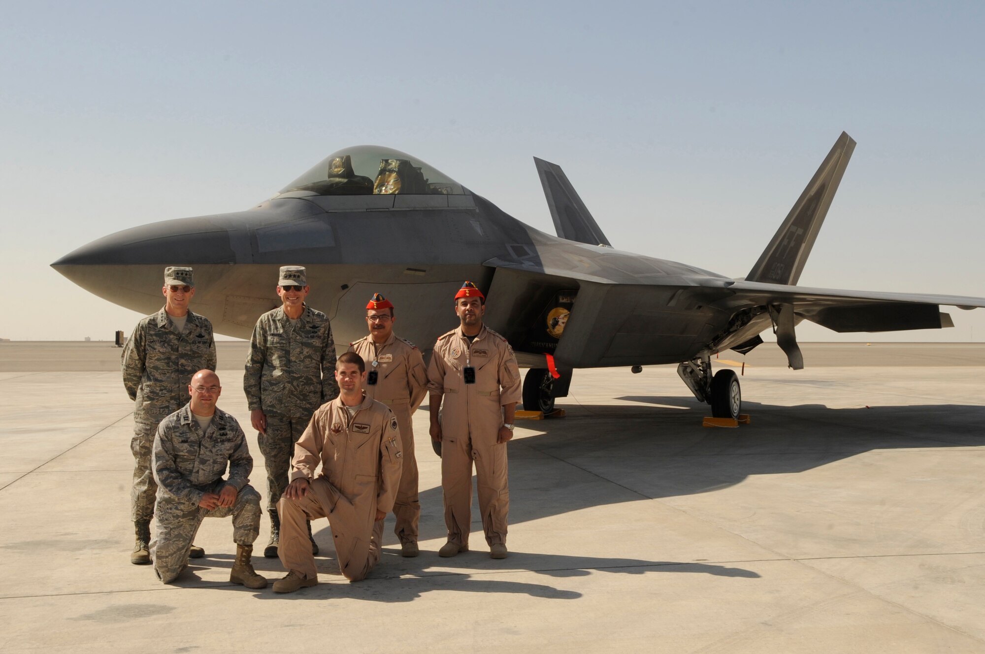 SOUTHWEST ASIA?Gen. Norton Schwartz, U.S. Air Force Chief of Staff, and Lt. Gen. Mike Hostage, U.S. Air Forces Central Command commander, pose with Emirati military members and crew members from Langley Air Force Base, Va., Nov. 13, 2009, in front of an F-22 Raptor during the aircraft?s first visit to the Gulf region.  U.S. Air Force F-22s are participating in bilateral training opportunities with Coalition partners at the United Arab Emirates Air Warfare Center through Dec. 10.  The training is intended to strengthen military-to-military relationships in the region, promote regional security, improve tactical air operations, and enhance interoperability of forces, equipment and procedures.  (U.S. Air Force photo/2nd Lt. Kidron B. Vestal)