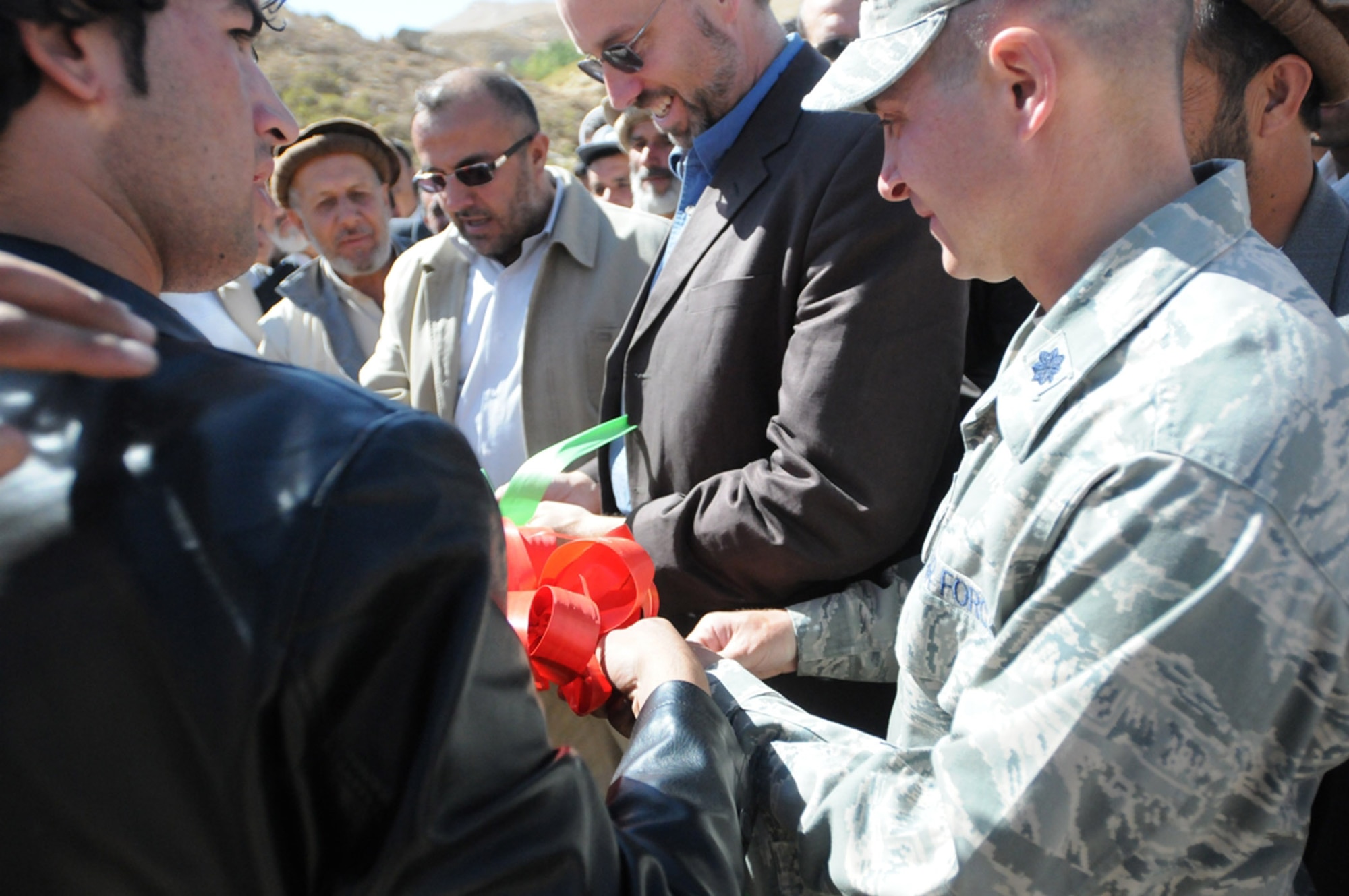 PANJSHIR PROVINCE, Afghanistan -- Panjshir Provincial Reconstruction Team commander, Lt. Col. Eric W. Hommel, (right) and PRT Director Mr. James DeHart (second from right) join Panjshir Governor Hajji Bahlol in a ribbon cutting ceremony officially opening Khermensan Road in Anaba district, Panjshir province, Afghanistan, recently. Civilian-Military integration is vital in the reconstruction efforts here in the Panjshir valley. (U.S. Air Force photo/Capt. John Stamm)