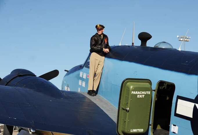 NELLIS AIR FORCE BASE, Nev.-- Ben Johnson stands on a Lockheed PV-2 Harpon aircraft and watches aircraft perform during the 2009 Aviation Nation Nellis Open House Nov. 15. The Nellis Open House is an opportunity for the Las Vegas community to view aerial demonstrations and static displays of various aircraft from the military. The open house also acts as the final air show of the year for the U.S. Air Force Aerial Demonstration Squadron Thunderbirds.
(U.S. Air Force photo by Master Sgt. Kevin J. Gruenwald)

