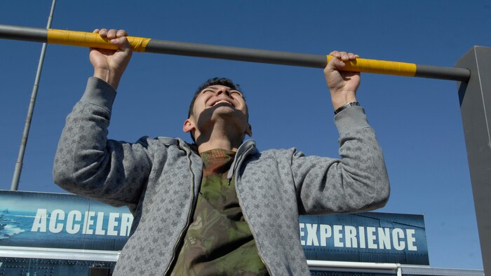 NELLIS AIR FORCE BASE, Nev.-- Andrew Purez, a local spectator, pushes his physical endurance while doing military style pull-ups at the Naval Special Operations Warfare exhibit during the 2009 Aviation Nation Nellis Open House Nov. 15. The Nellis Open House is an opportunity for the Las Vegas community to view aerial demonstrations and static displays of various aircraft from the military. The open house also acts as the final air show of the year for the U.S. Air Force Aerial Demonstration Squadron Thunderbirds.
(U.S. Air Force photo by Master Sgt. Kevin J. Gruenwald)
