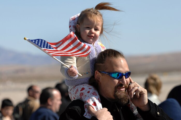 NELLIS AIR FORCE BASE, Nev. - Jeff Kimenker and his 22-month-old daughter Coralee enjoy the 2009 Aviation Nation Nellis Open House Nov. 15. The open house is an opportunity for the Las Vegas community to view aerial demonstrations and static displays of various aircraft from the military. The open house also acts as the final air show of the year for the U.S. Air Force Aerial Demonstration Team Thunderbirds.
(U.S. Air Force photo by Tech. Sgt. Michael R. Holzworth)
