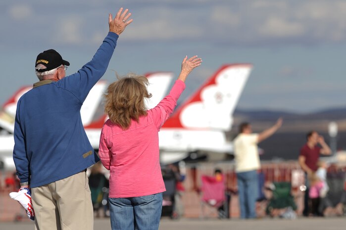 NELLIS AIR FORCE BASE, Nev.-- Retired U.S. Air Force Lt. Col. David Grey and his wife Barbara wave to a pilot taxiing down the Nellis runway at the 2009 Aviation Nation Nellis Open House Nov. 13. The open house is an opportunity for the Las Vegas community to view aerial demonstrations and static displays of various aircraft from the military. The open house also acts as the final air show of the year for the U.S. Air Force Air Demonstration Team Thunderbirds. (U.S. Air Force photo by Tech. Sgt. Michael R. Holzworth)