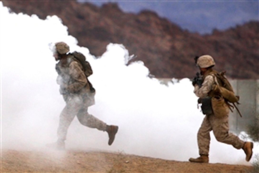 U.S. Marines rush through smoke and into buildings as they train and maintain their urban terrain skills at a combat range on Twentynine Palms, Calif., Nov. 11, 2009. The Marines are assigned to Company G, 2nd Battalion, 7th Marine Regiment. Company G is slated to deploy with the 31st Marine Expeditionary Unit in January and will be the battalion’s mechanized company.   