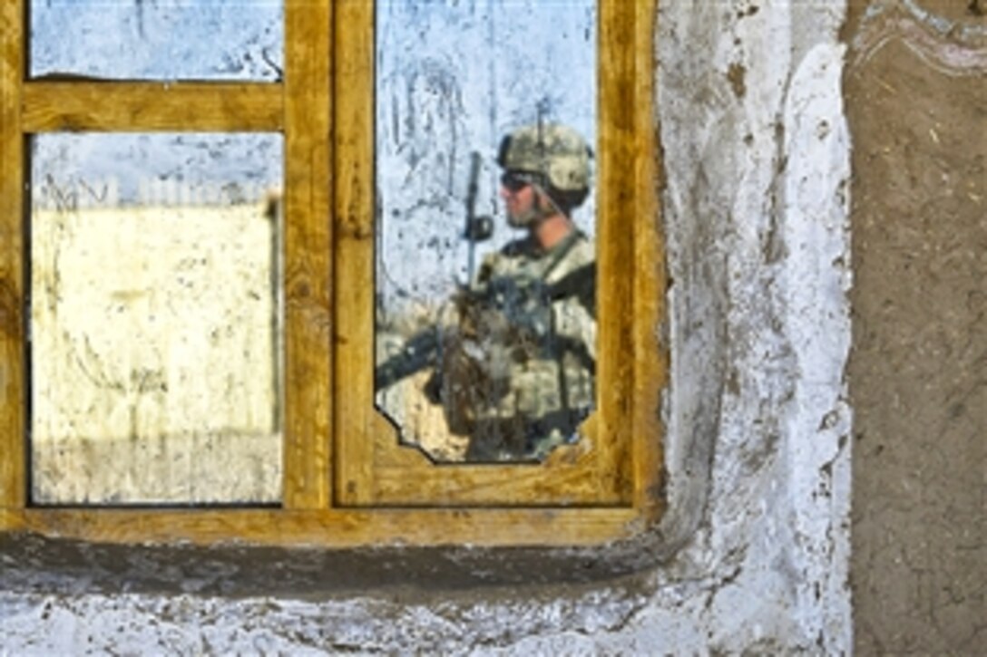 U.S. Army Staff Sgt. Mark Oravsky's reflection fills a window frame as he provides security at Suri Elementary School in the Suri Bazaar, Zabul province, Afghanistan, Nov. 14, 2009. Oravsky is assigned to the 2nd Infantry Division's 4th Battalion, 23rd Infantry Regiment, 5th Brigade. U.S. and Afghan soldiers are meeting with the school's teachers to discuss improvement opportunities.