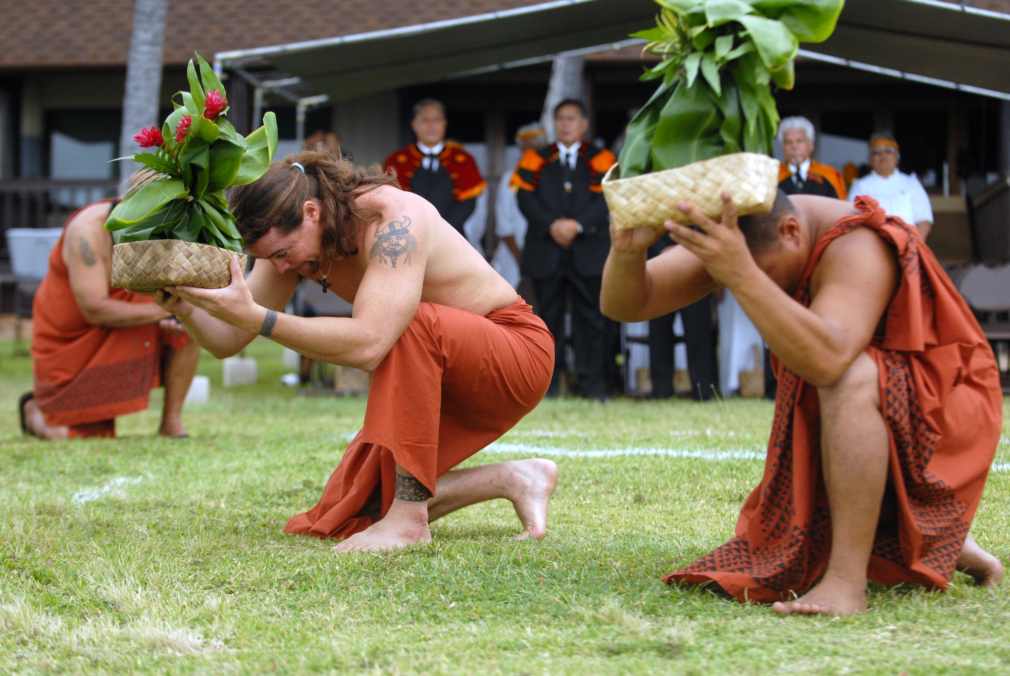 HICKAM AIR FORCE BASE, Hawaii -- Mark Naone and Kanoa Nelson offer gifts to Lono during the 7th Annual Kapuaikaula (Hickam) Makahiki (Thanksgiving) festival. Local Hawaiian and Hickam officials gathered at Hickam Harbor on Nov. 14 for the Makahiki festival. The festival involved a ceremonial arrival in canoes, spiritual offerings, five skills competitions and a feast to end the day. According to history texts, the Makahiki was started to honor Lono, the Hawaiian guardian of agriculture, rain, health and peace.(U.S. Air Force photo/Senior Airman Gustavo Gonzalez)