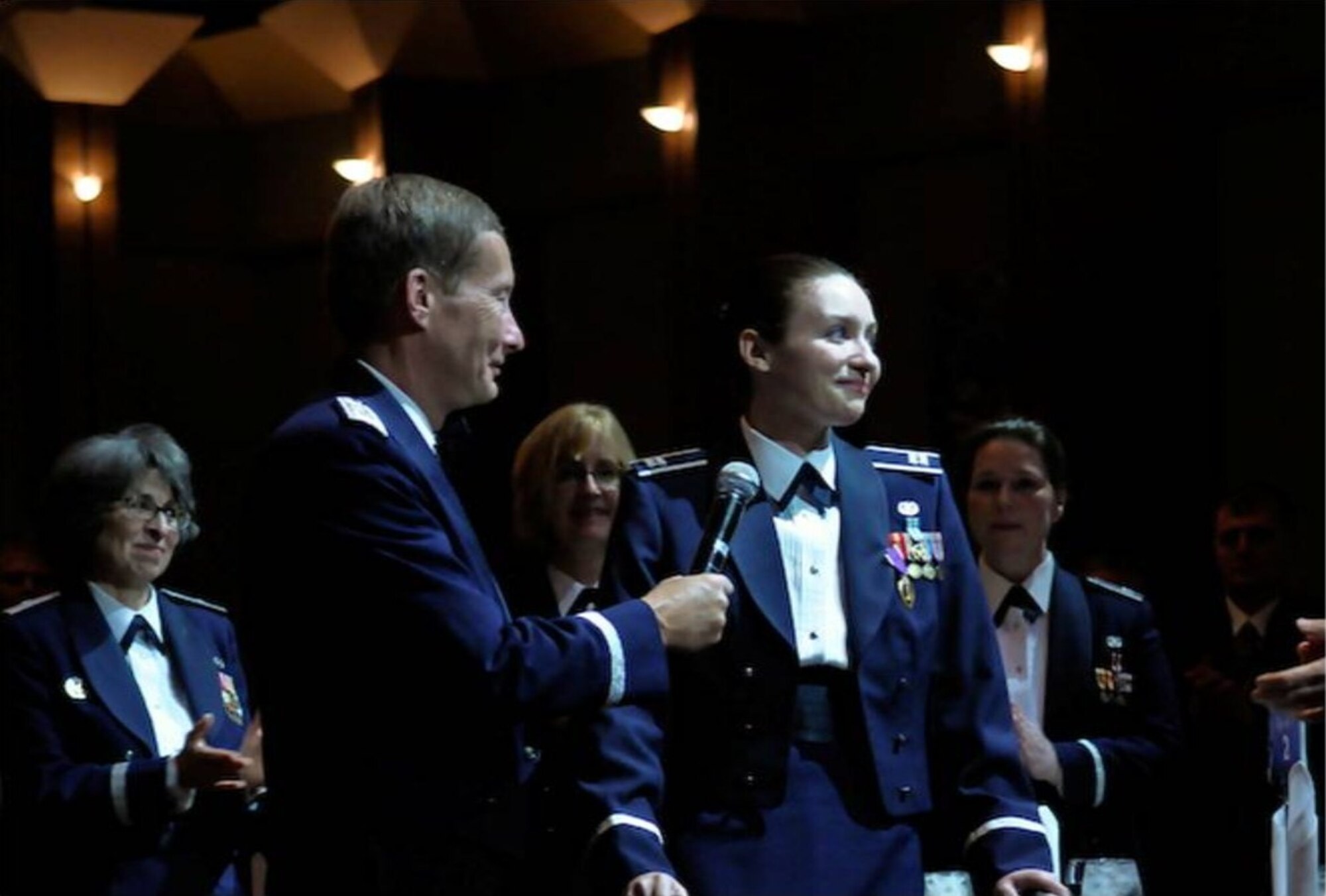 Maj. Gen. Charles Dunlap, the Air Force's deputy judge advocate general, speaks with Capt. Wendy Kosek, a Little Rock Air Force Base staff judge advocate, after awarding her a Purple Heart medal in a ceremony Oct. 29 at the Judge Advocate General's Keystone Leadership Conference in Dallas. (Courtesy photo)