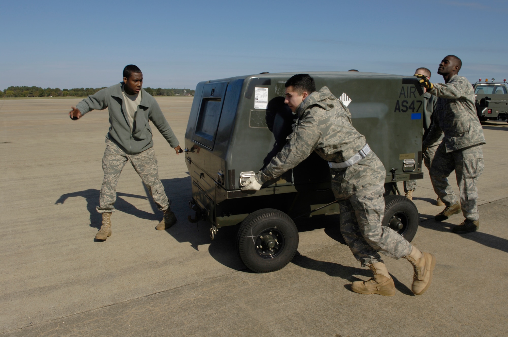 LANGLEY AIR FORCE BASE, Va. -- Members of the 1st Logistics Readiness Squadron wheel cargo onto a Russian AN-124 aircraft Nov. 4 for a deployment to United Arab Emirates.  Six 1st Fighter Wing F-22A Raptors are participating in bilateral training with Coalition partners from Nov. 15 to Dec. 10. (US Air Force Photo by Staff Sgt. Jeff Nevison)