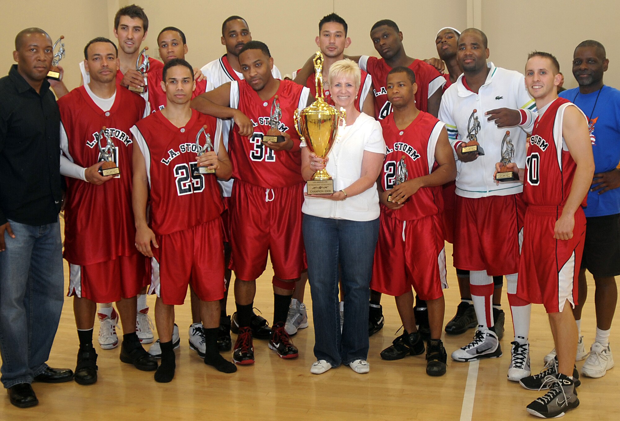Members of the LA Storm from Los Angeles Air Force Base stand with Col. Anita Latin (center), 61st Air Base Wing commander, after winning the championship trophy, Nov. 8. Los Angeles AFB sponsored the 2009 Veterans Day "SoCal Shootout" Basketball Tournament on Nov. 7 and 8, which included participation from Luke AFB, Travis AFB, Vandenberg AFB, and Edwards AFB. The LA Storm won the championship title with an 80 to 77 victory over Travis. (Photo by Atiba Copeland)