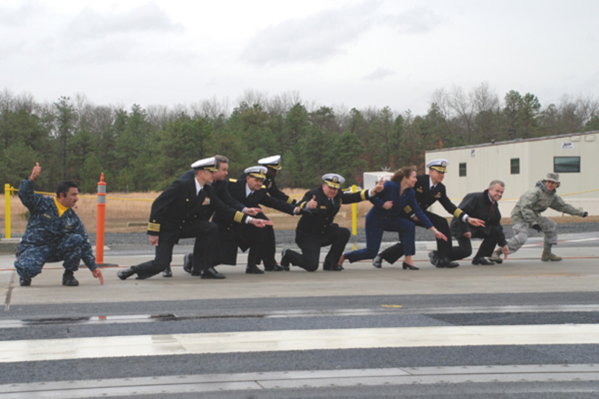NAVAIR and community leader "shoot" the first official movement of the Electromagnetic Aircraft Launch System Nov. 12 here. EMALS is an armature, the portion of a catapult that an aircraft tail hook connects to when it lifts off. This system will be installed on the next generation of aircraft carriers scheduled to become operational in 2015. (U.S. Navy photo/Sherry Jacob)


L-R: Chief Warrant Officer A. Melendez, NAVAIR test facility; Capt.R. Mahr, EMALS program manager, Representative C. Smith, Rear Adm. D. Philman, director Air Warfare Division, Cmdr. R. Griffin, NAVAIR program management office; Rear Adm M. McMahon, program executive officer for aircraft carriers; Capt. J. Donnelly,EMALS deputy program manager; K. Donnelly, director for support equipment/aircraft launching and recovery equipment; S. Forney, vice president of General Atomics; and Col. G. Grosso, Joint Base McGuire-Dix-Lakehurst commander.

