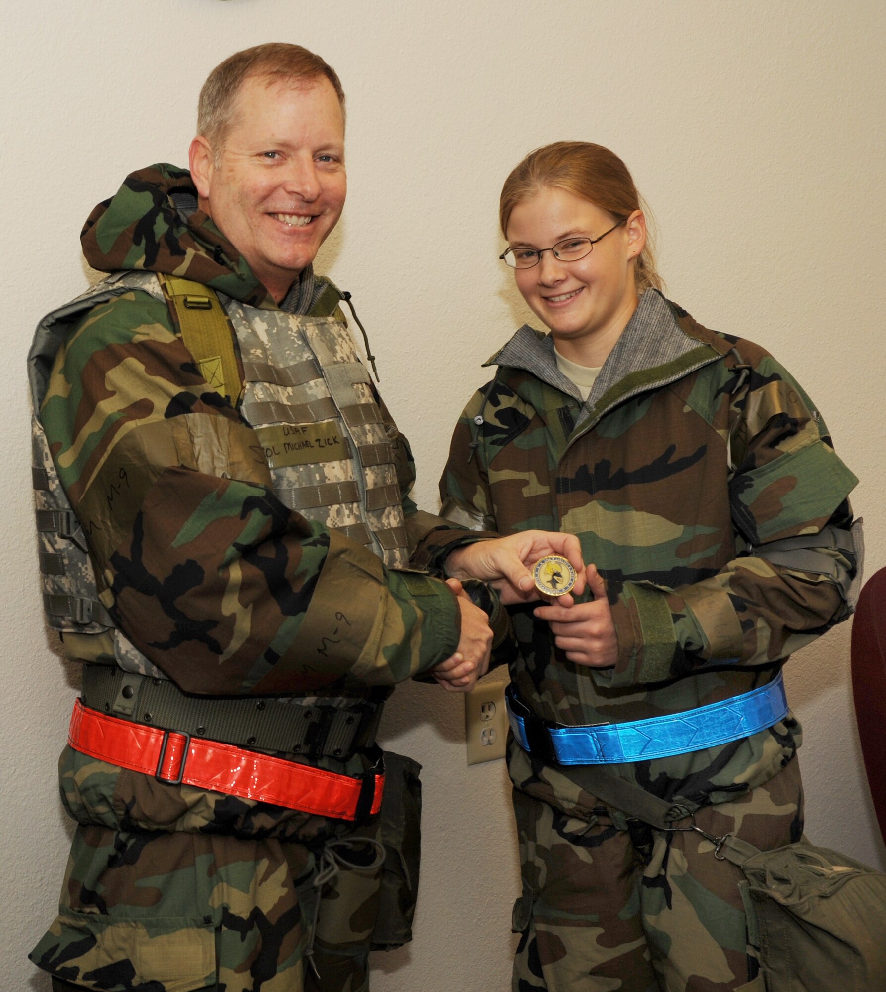 Col. Michael Zick, 19th Airlift Wing vice commander, presents a coin Nov. 17 to Airman 1st Class Shasta Sickinger, 19th Operations Group intelligence analyst, as the combat airlifter of the week. Airman Sickinger established critical asset lists as the 772nd Expeditionary Airlift Squadron antiterrorism monitor and prioritized 451st Air Expeditionary Wing, Kandahar Air Field, Afghanistan, assets for contingency operations. She also volunteered off-duty time to 451st AEW base honor guard.  (U.S. Air Force photo by Senior Airman Jim Araos)