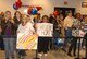 The families of TSgt Chris Hines and TSgt Dearlyn Gary hold up signs welcoming them back after an 8 month deployment to Southwest Asia, reuniting with their families on November 16, 2009 at McConnell AFB, KS. 