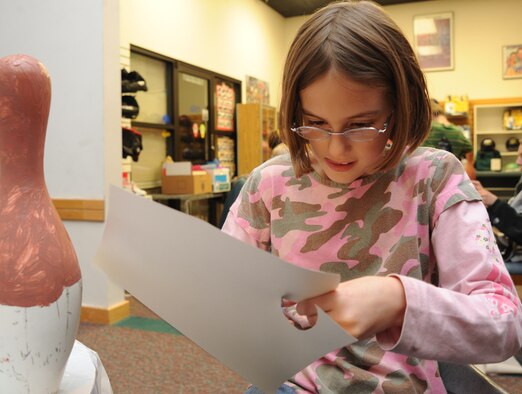 Team McConnell family member, Emma Chastain,9, cuts out paper feathers for a turkey pin, Nov. 16, 2009, during a Turkey Pin decorating contest at McConnell Air Force Base, Kan.  Children decorated more than 30 bowling pins. The 22nd Force Support Squadron members will announce contest winners during Tornado Alley’s annual turkey bowl, Nov. 21. (U.S. Air Force photo/Tech. Sgt. Chyrece Campbell) 