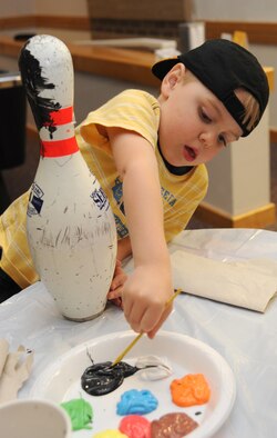 Team McConnell family member, Ethan Chastain, 3, decorates a bowling pin, Nov. 16, 2009, during a Turkey Pin decorating contest at McConnell Air Force Base, Kan. Children used art supplies to create the turkey pins, on display at the Tornado Alley until Nov. 21. Team McConnell members can vote for their favorite pins. The 22nd Force Support Squadron members will announce winners during Tornado Alley’s annual turkey bowl, Nov. 21. (U.S. Air Force photo/Tech. Sgt. Chyrece Campbell) 
