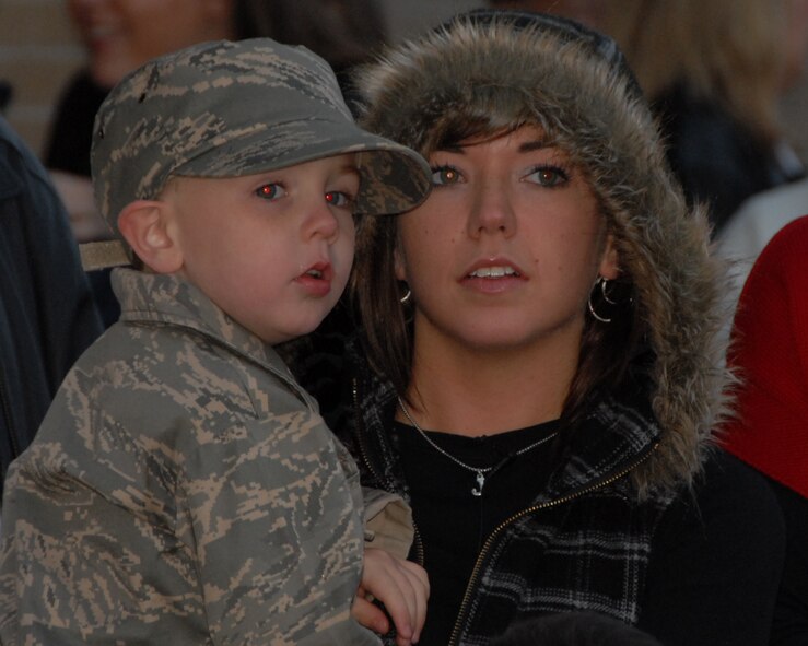 On November 16, 2009 at McConnell AFB, KS the family of SrA John Carpenter, deployed 184 SFS member, eagerly watches the flight line for signs of the plane that will bring him home.