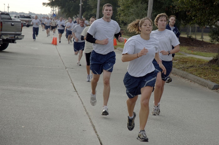Team Charleston members finish strong at the end of the Run the Runway 5K event honoring retired Brig. Gen. Thomas Mikolajcik here on Wingman Day Nov. 17. More than 800 Team Charleston members participated in the run which lead through part of the base and onto the runway. (U.S. Air Force photo/Staff Sgt. Marie Brown)