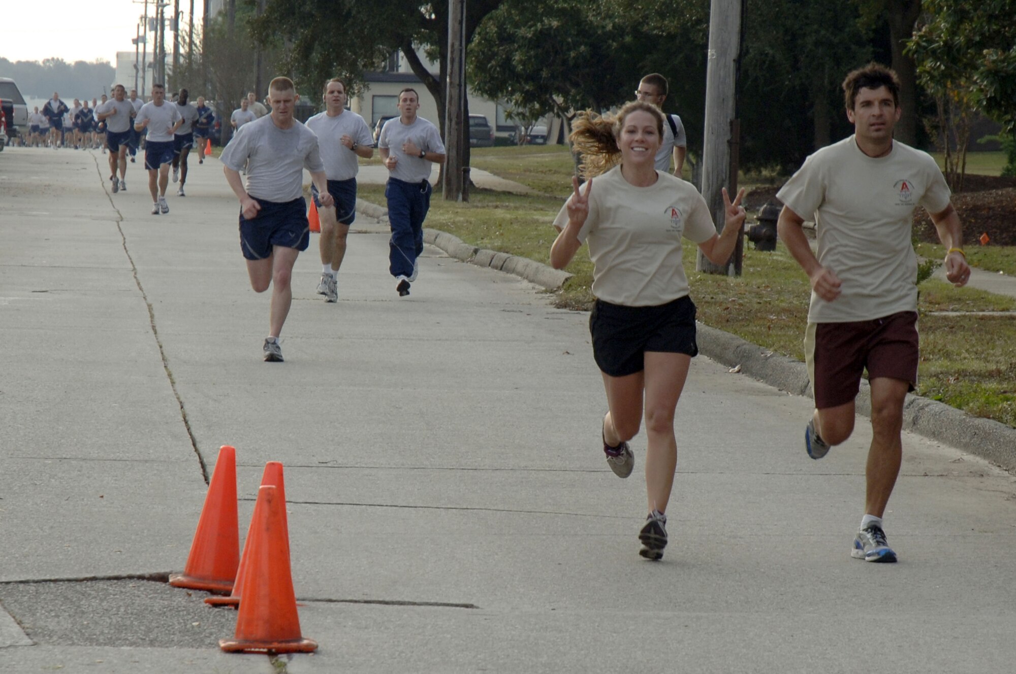 Capt. Holly Kingston, left, and Jacob Kingston make a finish strong during the Run the Runway 5K event honoring retired Brig. Gen. Thomas Mikolajcik here on Wingman Day Nov. 17. Captain Kingston and Jacob wore custom designed t-shirts purchased to support amyltrophic lateral sclerosis awareness and the ALS Association, South Carolina Chapter. Captain Kingston is a clinical nurse assigned to the 437th Medical Group and Jacob is her husband. (U.S. Air Force photo/Staff Sgt. Marie Brown)