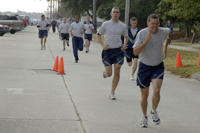 Team Charleston members approach the finish line during the Run the Runway 5K event honoring retired Brig. Gen. Thomas Mikolajcik here on Wingman Day Nov. 17. The 5K marked the first Run the Runway event at Charleston AFB and is envisioned to be held annually in support of amyotrophic lateral sclerosis awareness. (U.S. Air Force photo/Staff Sgt. Marie Brown)