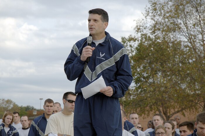 Col. Joseph Mancy gives the welcoming remarks prior to the start of the Run the Runway 5K event honoring retired Brig. Gen. Thomas Mikolajcik here on Wingman Day Nov. 17. The event was envisioned by base leadership and the Amyotrophic Lateral Sclerosis, South Carolina Chapter to raise awareness of ALS. Colonel Mancy is the 437th Operations Group commander. (U.S. Air Force photo/Staff Sgt. Marie Brown)