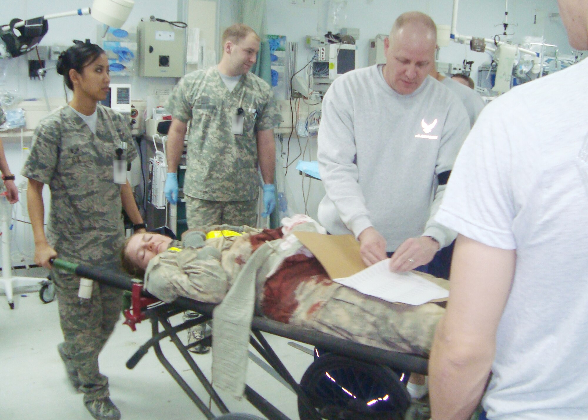 Airmen and Soldiers at the Craig Joint Theater Hospital tend to a simulated "victim" during a mass-casualty exercise Nov. 13, 2009, at Bagram Airfield, Afghanistan. Recently, Airmen and Soldiers found the exercise useful when an insurgent rocket attack targeted a civilian marketplace in the nearby Tagab Valley. Thirteen Afghan civilians were medically evacuated to Bagram's hospital after the attack. (U.S. Air Force photo/Capt. James McDaniel)
