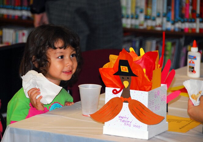 Trisha Ray enjoys a cookie with her mother after completing her Thanksgiving turkey at the Family Craft Night held here Nov. 12. The craft night was held from 6 to 8 p.m. and Base Library staff provided all the supplies needed for the craft, along with cookies, chocolates and juice for refreshments. Trisha is the daughter of Patrick Ray who is a retired master sergeant with the 437th Medical Group. (U.S. Air Force photo/Staff Sgt. Daniel Bowles)