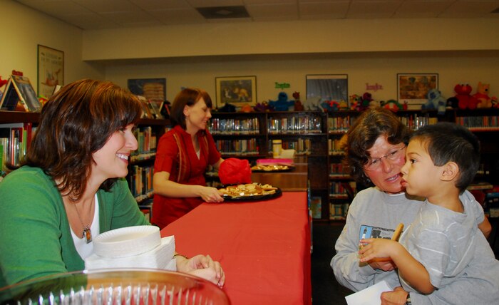 Angela Aschenbrenner wishes Nitsa and Gregory Calas goodnight after the Family Craft Night held at the Base Library here Nov. 12. Along with many existing programs, Family Craft Nights help to enhance the lives of families and provides options for healthy family activities during the Year of the Air Force Family. Ms. Aschenbrenner is the Base Library director, Ms. Calas is the wife of Army Ch. Capt. Lyde Calas who is deployed to the Middle East and Gregory is their grandson. (U.S. Air Force photo/Staff Sgt. Daniel Bowles)